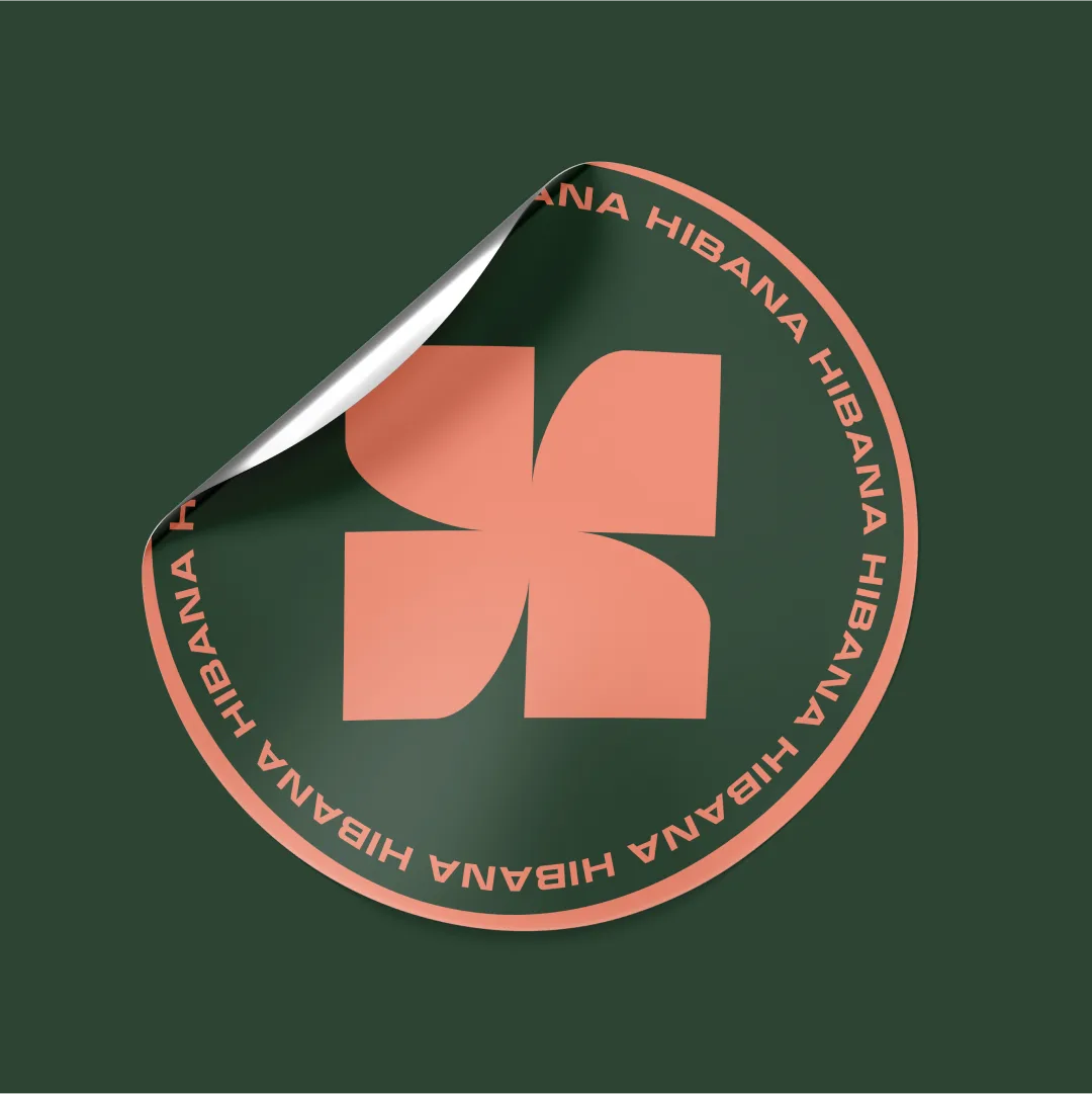 A round Hibana sticker with the spark mark and circular wordmark, corner peeling