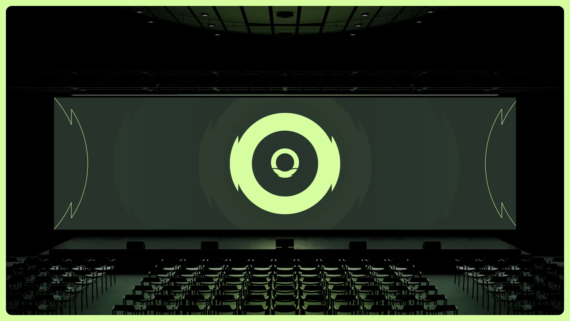 A dark auditorium with the MedCraft ring mark glowing on a wide keynote screen
